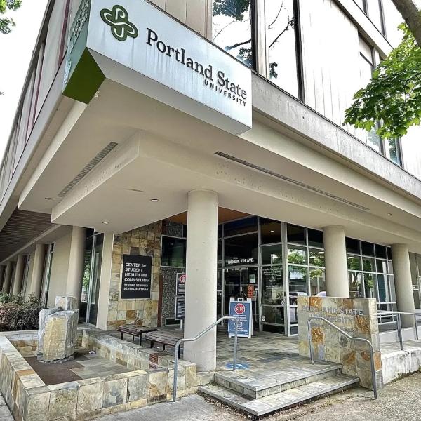 Portland State University, main entry of UCB building with stairs, a water fountain, windows and a door.