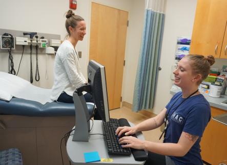 Health Services provider room with a patient sitting on chair.