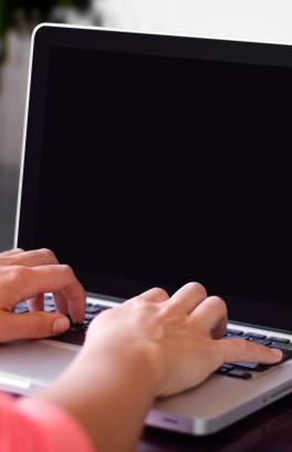 This photo is decorative. A person typing on a computer.