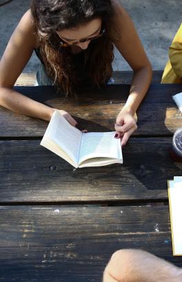 Students sitting at a table outside.