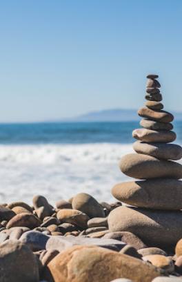 Pile of rocks next to the beach on a sunny day.