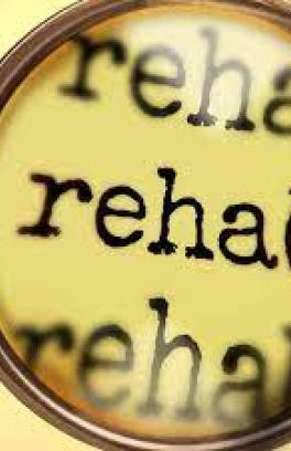 a magnifying class that is focused on the word "rehab"