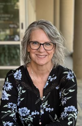 Christi headshot in front of SHAC