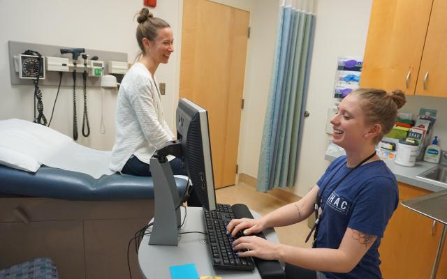 Health Services provider room with a patient sitting on chair.