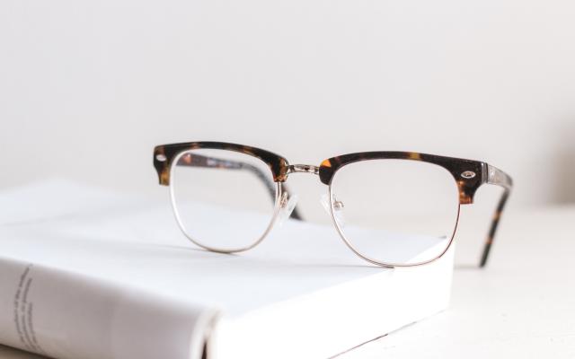 eye glasses sitting on a white book.