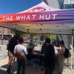 Rainbow pop up tent outside on campus representing "The Hut".