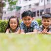 Happy children lying on the grass