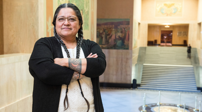 Representative Tawna D. Sanchez with her arms crossed standing in House of Representatives