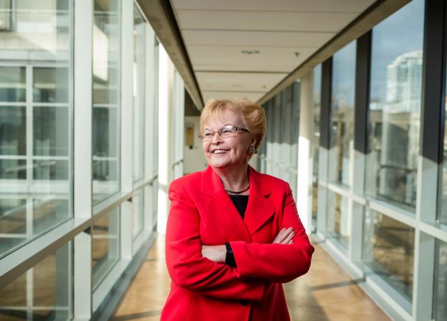 Former Gov. Barbara Roberts in red suit with arms crossed