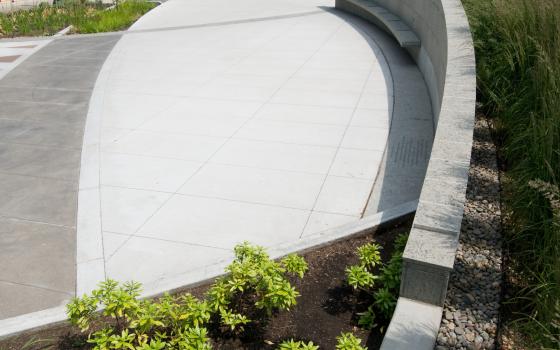 Curved stone wall and plants