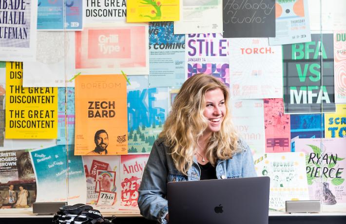 woman with macbook smiling