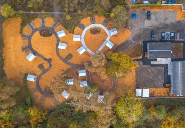 A bird's eye view of an in-progress Clackamas County Veterans Village. The ground is covered in orange leaves.