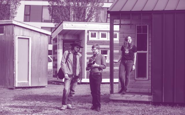 purple duotoned image of people standing outside
