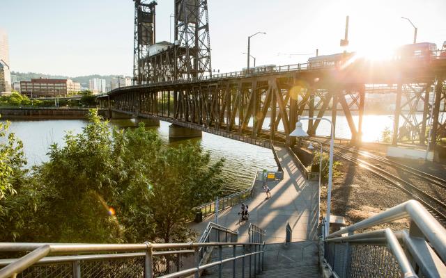 Steel Bridge in Portland with trees and pedestrian walkway in foreground