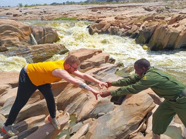Kenya students hiking on rocks
