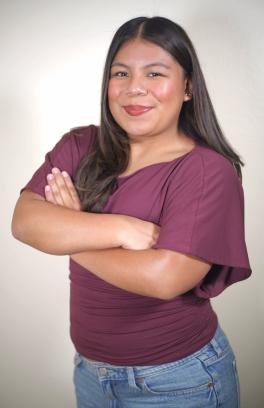 Belinda in a purple shirt with her arms crossed
