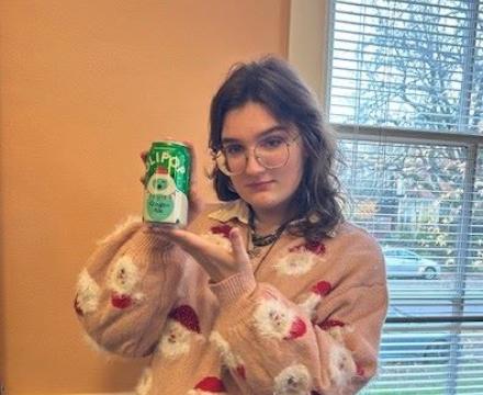 Chayse, Honors Student holding a can of soda