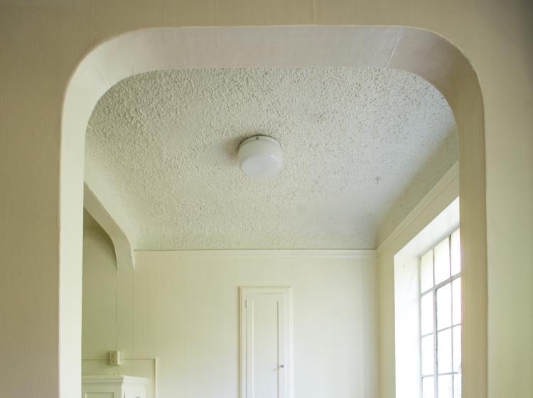 Archway entrance to kitchen of unfurnished one bedroom