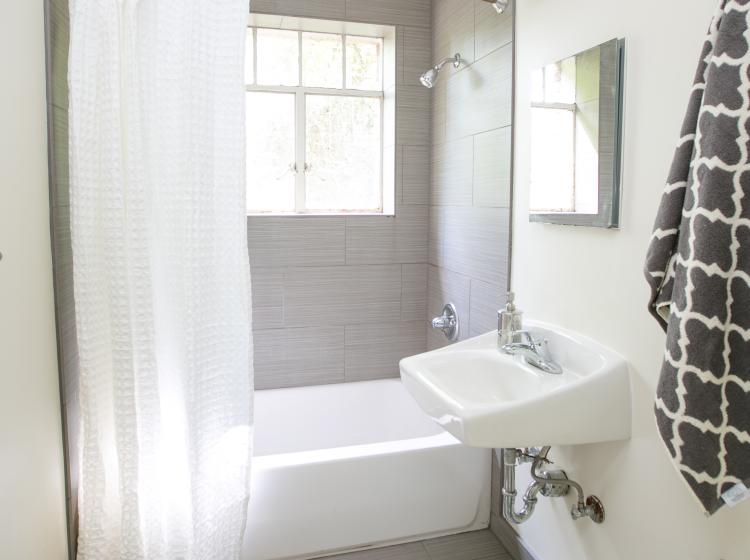 Bathroom with tub and shower in furnished quad
