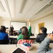 Student in classroom raising her hand