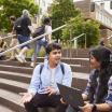 Two students sitting on the steps in urban plaza