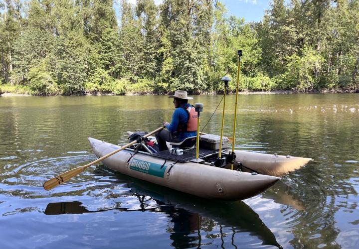 Photo of a researcher collecting depth, velocity, water surface elevation, and 360 degree imagery on the North Santiam River.