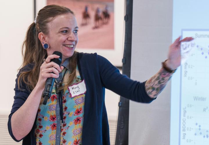 Student Mary Munt points at her data displayed on a projection screen.