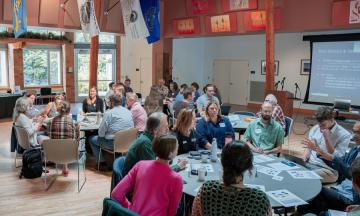 USGS staff and PSU faculty sitting at tables in breakout groups during the UPP Symposium