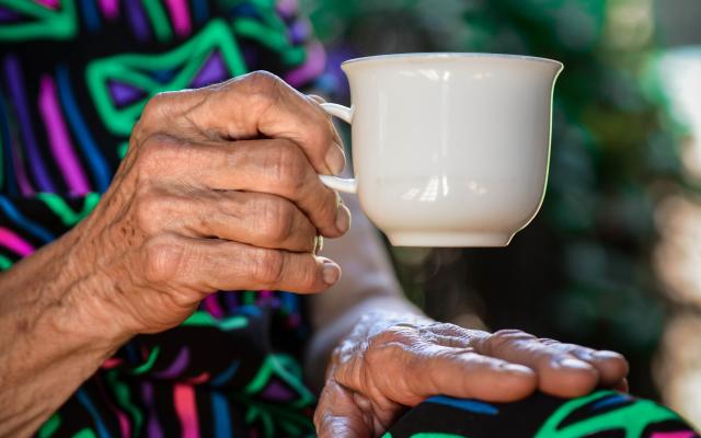 Older woman holding coffee cup