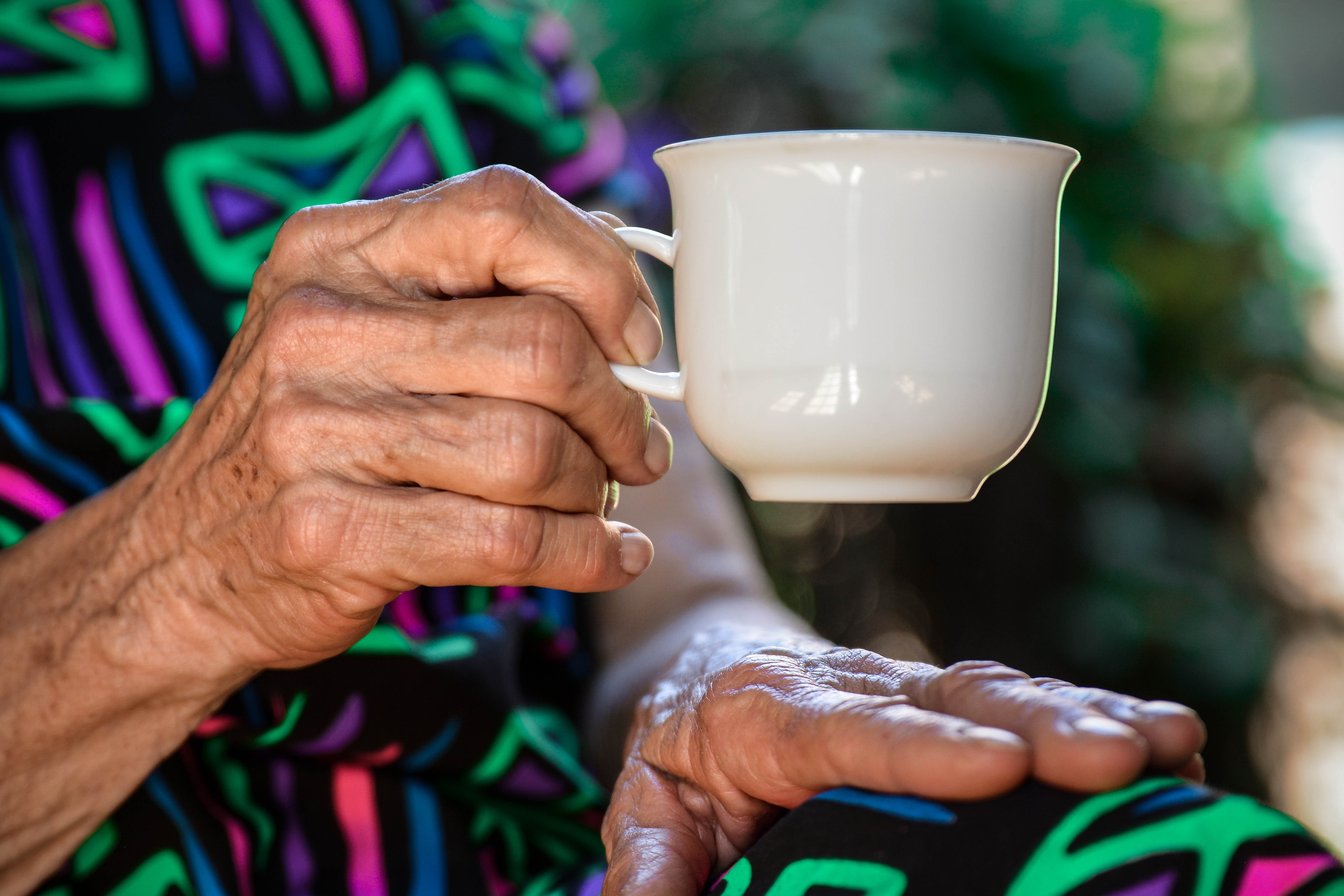 Older woman holding coffee cup