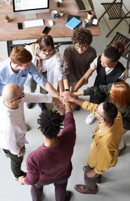 Group of people joining hands