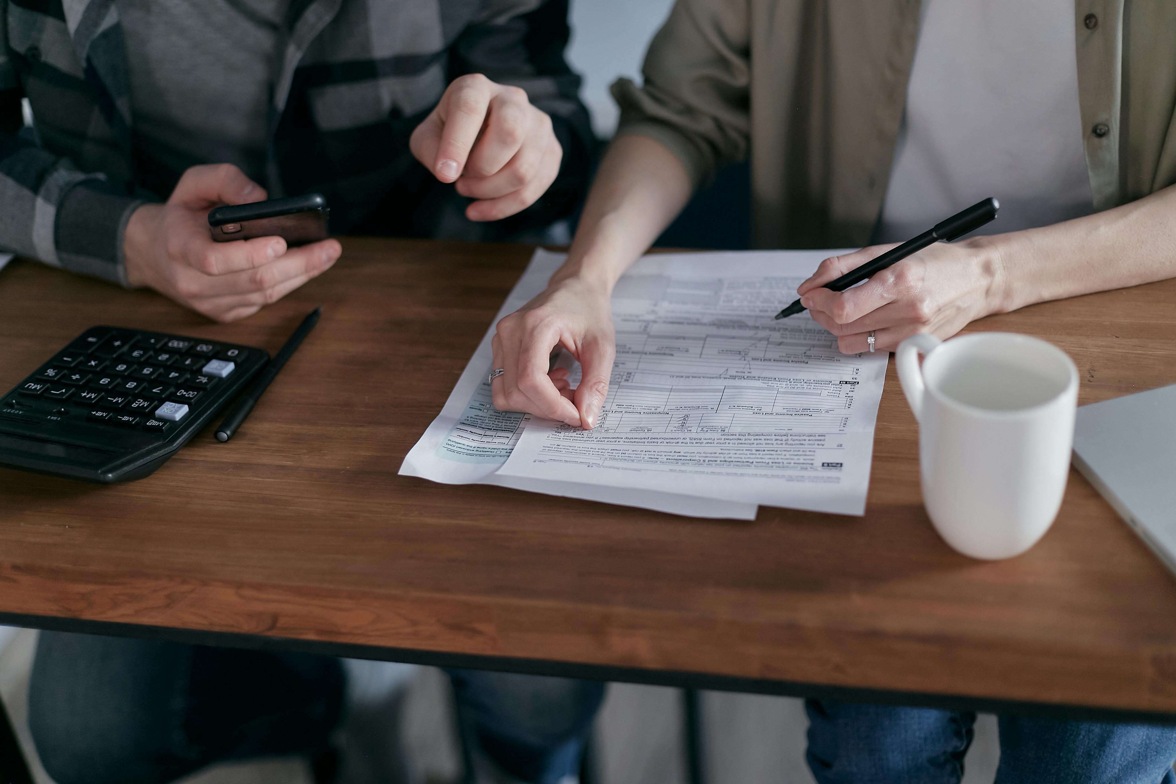 Two people working on tax forms