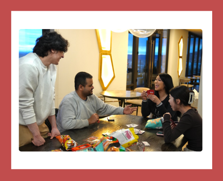 Group of international and domestic students playing the Exploding Kittens Card Game
