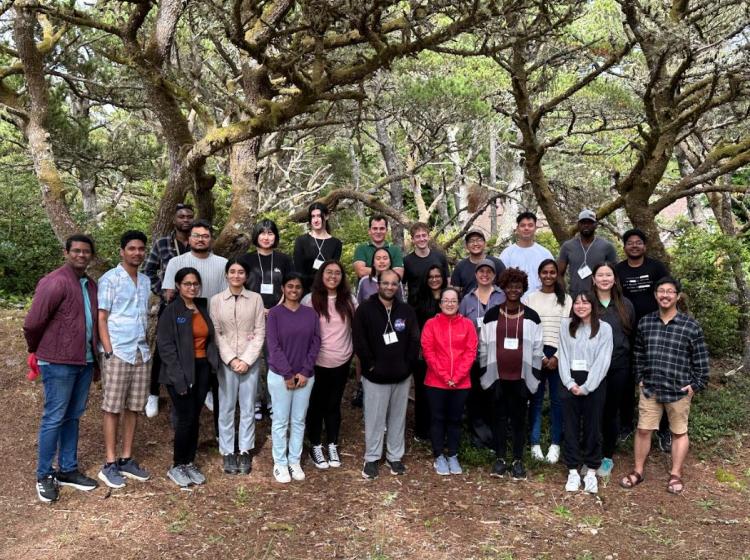 Group of students standing outside pose for photo.