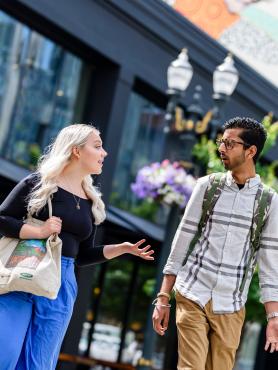 Friends talking outside a building downtown