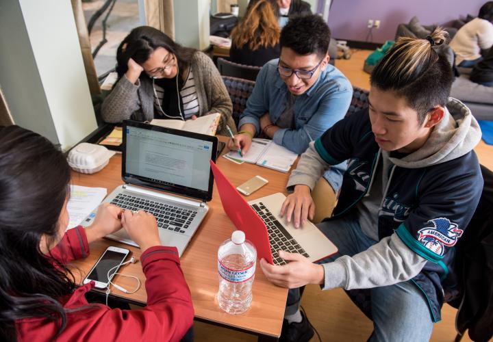 Students working on laptops in the library