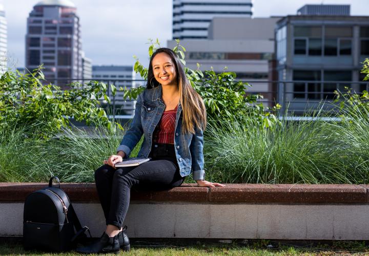 Student relaxing on rec center patio