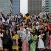 Spring 2022 Graduates stand together in a group celebrating their graduation