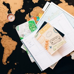 Passport and other travel documents on top of a world map