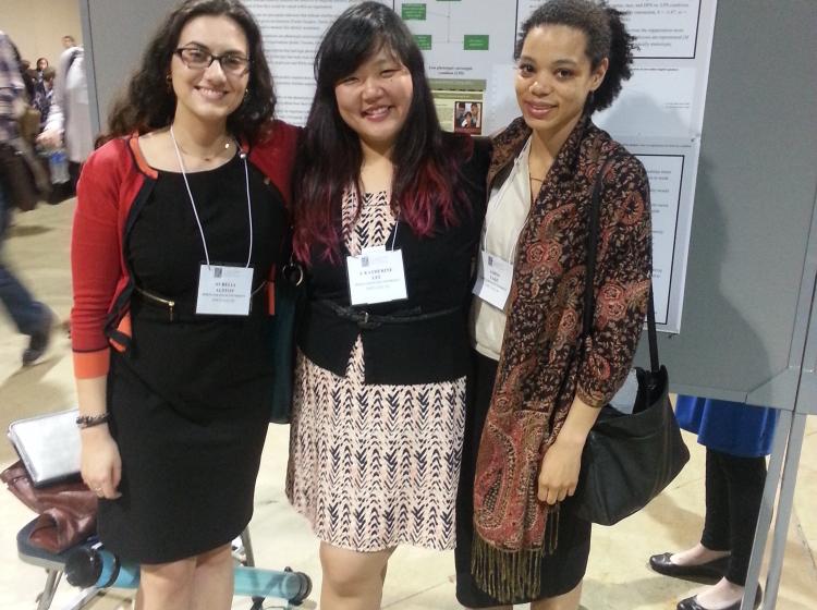GRASP Lab members Aurelia Alston, J. Katherine Lee, and Jaboa Lake standing in front of an academic poster at SPSP 2015.