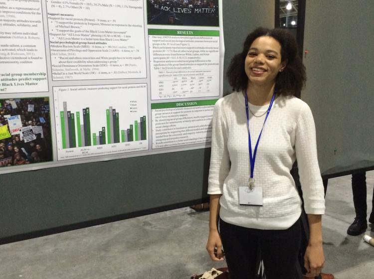 Jaboa Lake standing in front of her poster at SPSP 2016 annual conference. The poster is titled: "Solidarity and social justice: Support for protest efforts and the Black Lives Matter movement"