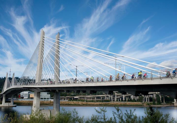 Portland's Tillikum bridge with many cyclists on it.