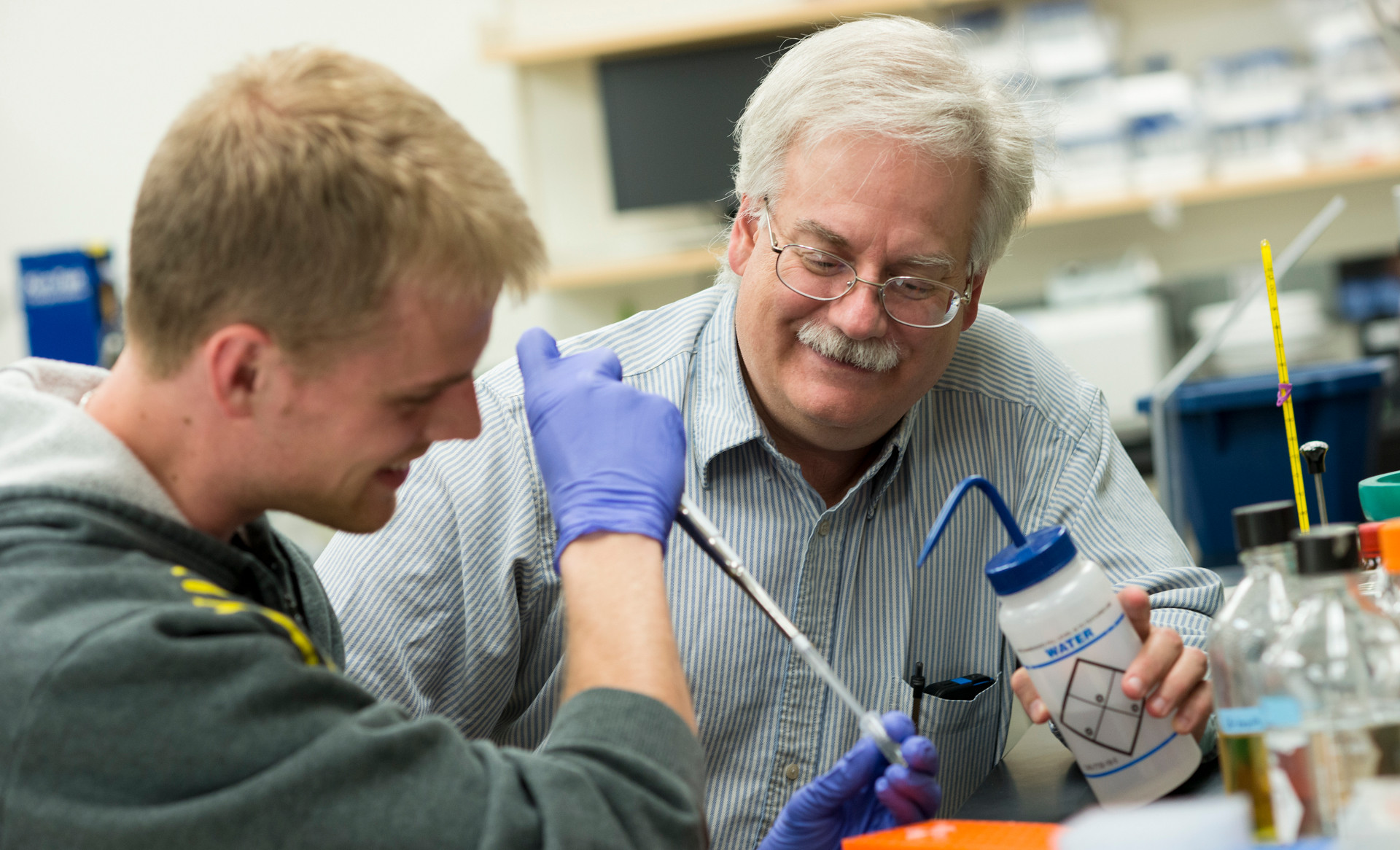 Professor and student doing chemistry experiment