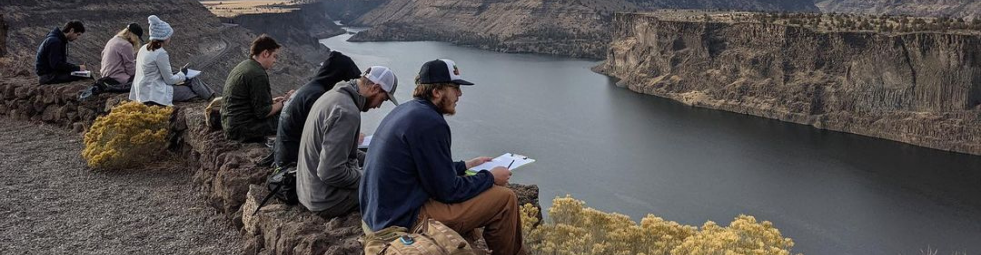 Geology students overlooking lake during field trip