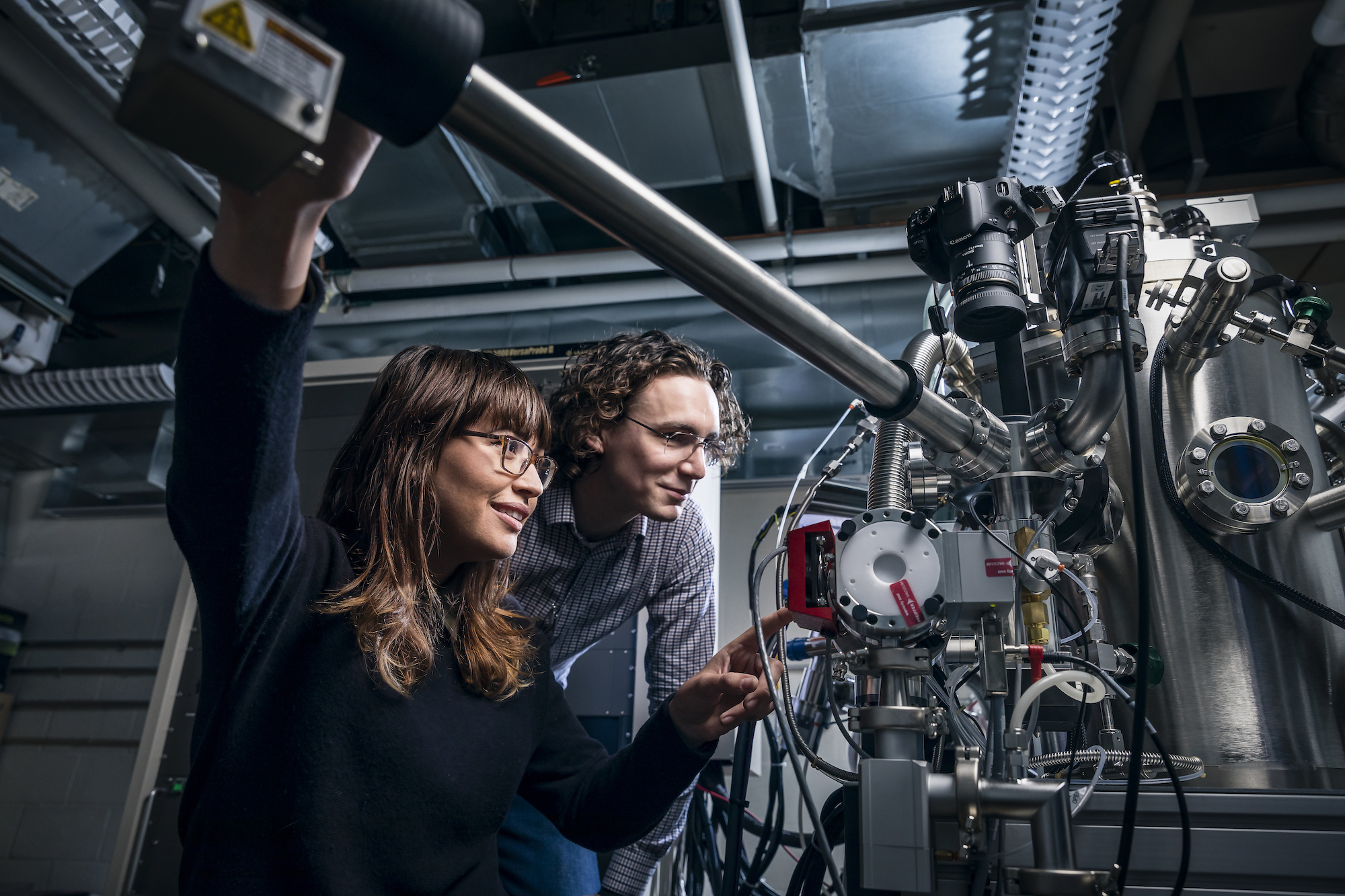 Students operating a large microscope