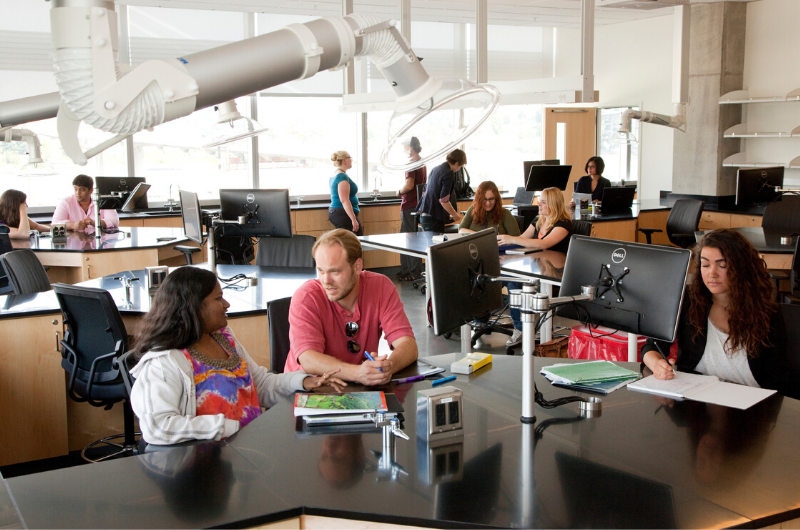 Students conversing in science lab classroom