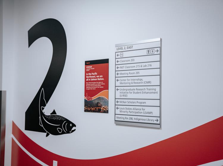 Directional signage on wall that represents salmon