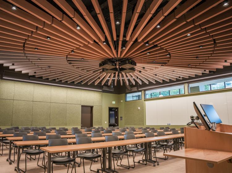 Large lecture room with wooden circular ceiling feature