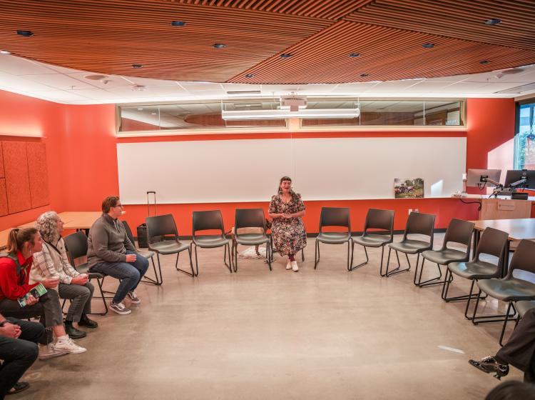 People seated in round in community classroom in Vernier Science Center