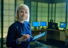 Woman standing with tablet